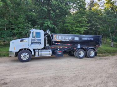 Truck ready to deliver dumpster